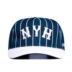 Load image into Gallery viewer, A navy blue cap with pinstripe pattern and the letters 'NYH' in white on the front.
